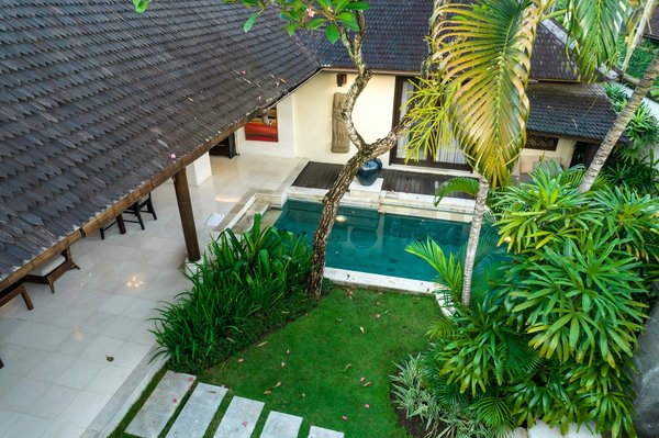 How can you integrate a water feature into a small UK backyard pool?